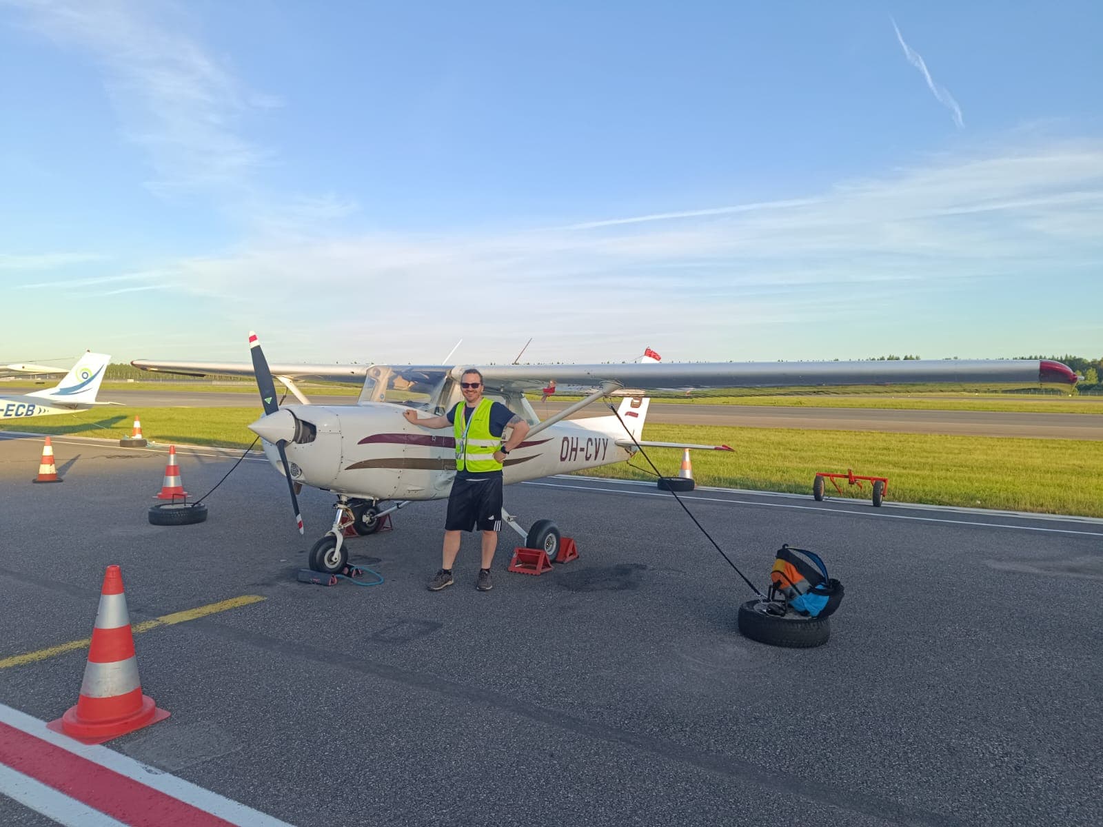 Viljar beside a light aircraft on the apron before a flight
